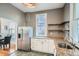 Bright kitchen featuring granite countertops, stainless steel refrigerator, and convenient shelving at 3427 W 29Th Ave, Denver, CO 80211