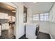 Bright laundry room with tile flooring and modern front-loading washer and dryer at 3427 W 29Th Ave, Denver, CO 80211