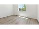 Bright bedroom features sleek flooring and natural light from a large window at 18951 E 96Th Pl, Commerce City, CO 80022