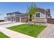 Exterior showcasing well-manicured lawn and a two-car garage at 18951 E 96Th Pl, Commerce City, CO 80022