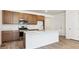 Modern kitchen featuring stainless steel appliances and a large island at 18951 E 96Th Pl, Commerce City, CO 80022