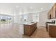Modern kitchen features an island, stainless appliances, and an open floor plan at 18951 E 96Th Pl, Commerce City, CO 80022
