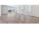 Open-concept living room with sleek flooring and lots of natural light at 18951 E 96Th Pl, Commerce City, CO 80022