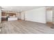 Bright living room features wood floors and an open concept layout with kitchen and modern appliances at 18951 E 96Th Pl, Commerce City, CO 80022