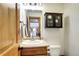 Charming bathroom features a single vanity and dark wood cabinet for storage at 1391 S Winston Dr, Golden, CO 80401