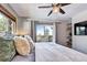 Cozy bedroom with ceiling fan, mountain views, and built-in shelving at 1391 S Winston Dr, Golden, CO 80401