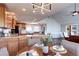 Inviting dining area with a wooden table, comfortable seating, and views into the living room and kitchen at 1391 S Winston Dr, Golden, CO 80401