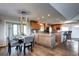 Open concept dining area leading into a kitchen with wood cabinets and a breakfast bar at 1391 S Winston Dr, Golden, CO 80401