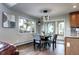 Charming dining area featuring a modern light fixture and a large window offering stunning views of the landscape at 1391 S Winston Dr, Golden, CO 80401