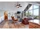 Bright living room featuring a stone fireplace, built-in shelves, and large windows with scenic views at 1391 S Winston Dr, Golden, CO 80401