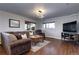 Comfortable living room with hardwood floors, a large sofa, and natural light at 1391 S Winston Dr, Golden, CO 80401