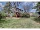 Serene backyard setting with lush greenery, mature trees, and a well-kept lawn at 17912 E Milan Pl, Aurora, CO 80013
