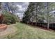 Expansive backyard featuring lush lawns, mature trees, and privacy fencing at 17912 E Milan Pl, Aurora, CO 80013
