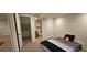 A cozy bedroom with plush carpet and an adjacent bathroom offers comfort and convenience at 17912 E Milan Pl, Aurora, CO 80013