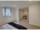 Well-lit bedroom with a cozy carpet and an adjacent bonus room perfect for relaxing at 17912 E Milan Pl, Aurora, CO 80013