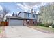 Charming two-story home with a well-manicured lawn and a detached two-car garage at 17912 E Milan Pl, Aurora, CO 80013