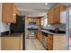Kitchen with stainless steel appliances, hardwood cabinets, and granite countertops at 17912 E Milan Pl, Aurora, CO 80013