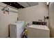 Functional laundry room with washer and dryer units, optimizing space and convenience at 17912 E Milan Pl, Aurora, CO 80013