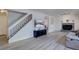 Bright living room featuring hardwood floors, fireplace, and staircase at 17912 E Milan Pl, Aurora, CO 80013