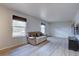 Bright living room with hardwood floors and large windows allowing plenty of natural light at 17912 E Milan Pl, Aurora, CO 80013