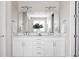 Bathroom with double vanity, quartz countertop, under-cabinet storage, stylish lighting, and a large mirror at 533 Red Thistle Dr, Highlands Ranch, CO 80126