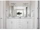 Bright bathroom featuring dual sinks, white cabinetry, and modern fixtures at 533 Red Thistle Dr, Highlands Ranch, CO 80126