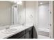 Clean and bright bathroom with dual sinks, modern fixtures, and a separate shower at 533 Red Thistle Dr, Highlands Ranch, CO 80126