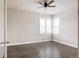 Light-filled bedroom featuring hardwood floors, a ceiling fan, and bright windows at 533 Red Thistle Dr, Highlands Ranch, CO 80126