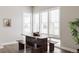 Breakfast nook with light-filled window with white shutters and a farmhouse style wooden table at 533 Red Thistle Dr, Highlands Ranch, CO 80126