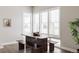 Bright dining area featuring a wooden table with benches and large windows at 533 Red Thistle Dr, Highlands Ranch, CO 80126