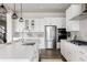 Bright and airy kitchen featuring white cabinets, stainless steel appliances, and a center island at 533 Red Thistle Dr, Highlands Ranch, CO 80126