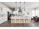 Stylish kitchen featuring white cabinets, modern lighting, and stainless steel appliances at 533 Red Thistle Dr, Highlands Ranch, CO 80126