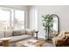 Cozy living room featuring a comfortable sofa, ottoman, large window, and stylish decor at 533 Red Thistle Dr, Highlands Ranch, CO 80126