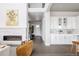 Open concept living room with a fireplace, leading to a modern kitchen and hallway at 533 Red Thistle Dr, Highlands Ranch, CO 80126