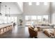 Open-concept living space with high ceilings, large windows, and stylish furnishings perfect for modern living and entertaining at 533 Red Thistle Dr, Highlands Ranch, CO 80126