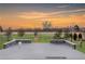 Exterior patio area overlooking a beautifully landscaped neighborhood with open skies at sunset at 533 Red Thistle Dr, Highlands Ranch, CO 80126