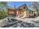 Back exterior featuring a mix of brick and siding, a cozy patio, and a functional layout at 5475 W 1St Ave, Lakewood, CO 80226