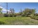 A backyard view with green grass and mature bushes at 5475 W 1St Ave, Lakewood, CO 80226