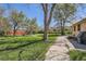 Expansive backyard with mature trees and lush greenery, perfect for outdoor activities at 5475 W 1St Ave, Lakewood, CO 80226