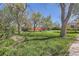 A backyard features a large green lawn and large shade trees at 5475 W 1St Ave, Lakewood, CO 80226