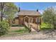 Charming brick home with a welcoming ramp and lovely landscaping in a serene setting at 5475 W 1St Ave, Lakewood, CO 80226