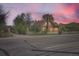 Charming brick home with a white picket fence and mature trees under a beautiful sky at 5475 W 1St Ave, Lakewood, CO 80226