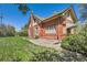 Brick house with ample windows, a vintage awning and a manicured lawn at 5475 W 1St Ave, Lakewood, CO 80226