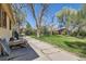 An exterior landscape view showcases the side yard and lawn at 5475 W 1St Ave, Lakewood, CO 80226