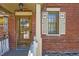 Charming front door and window with decorative shutters on a classic brick home at 5475 W 1St Ave, Lakewood, CO 80226