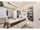 Bright bathroom showcasing a double sink, vanity, and access to the main bedroom at 5758 S Jasper Way, Centennial, CO 80015