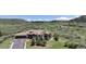 A stunning aerial view of a beautiful home with a three-car garage, lush greenery, and rolling hills at 1272 Nightfire Cir, Castle Rock, CO 80104