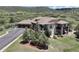 Aerial view of an elegant home with a three-car garage, mature landscaping, and a gorgeous mountain backdrop at 1272 Nightfire Cir, Castle Rock, CO 80104