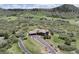 Aerial view showcasing a spacious home and driveway surrounded by lush greenery and beautiful mountain scenery at 1272 Nightfire Cir, Castle Rock, CO 80104