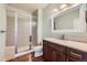 Bathroom featuring walk-in shower with glass doors, tile floors, and vanity with marble countertop at 1272 Nightfire Cir, Castle Rock, CO 80104